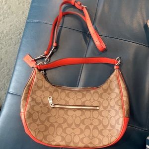 Coach bag with over the shoulder strap.